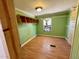 Bright bedroom with light green walls, wood flooring and built-in shelves at 255 Roberts Ave, Henderson, NC 27537