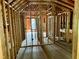Unfinished upstairs bedroom with exposed framing and a large window at 255 Roberts Ave, Henderson, NC 27537