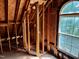 Unfinished upstairs bedroom with exposed framing and a large window at 255 Roberts Ave, Henderson, NC 27537