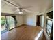 Living room with laminate floors, a sliding glass door, and a ceiling fan at 255 Roberts Ave, Henderson, NC 27537