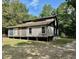 Rustic one-story home with wooden siding needing some repairs at 255 Roberts Ave, Henderson, NC 27537