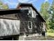 Rustic one-story home with wooden siding needing some repairs at 255 Roberts Ave, Henderson, NC 27537
