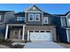 Two-story home with gray siding, brick accents, and a two-car garage at 197 Beacon Dr, Pittsboro, NC 27312