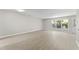 Spacious living room featuring light grey vinyl flooring and large windows at 15 Providence Ct, Durham, NC 27705