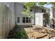 Private patio with brick walkway, small tree, and wood fence at 15 Providence Ct, Durham, NC 27705