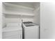Convenient laundry room with washer, dryer, and shelving at 15 Providence Ct, Durham, NC 27705
