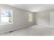 Bright bedroom with neutral walls and carpet at 15 Providence Ct, Durham, NC 27705