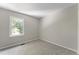 Bright bedroom with neutral walls and carpet, featuring a window with natural light at 15 Providence Ct, Durham, NC 27705