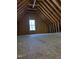 Large unfinished attic space with wood framing and single window at 90 River Rock Way, Franklinton, NC 27525