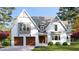 Two-story white house with gray roof, double garage doors, and landscaping at 3340 Colby Chase Dr # 2, Apex, NC 27539
