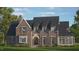 Brick two-story house with a gabled roof, dormers, and landscaping at 401 Marlowe Rd, Raleigh, NC 27609
