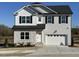 Two-story house with gray siding, white accents, and a two-car garage at 350 Pecan Valley Way, Four Oaks, NC 27524