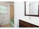 Updated bathroom features a green tub, tiled walls, and a dark wood vanity at 683 Baynes Rd, Burlington, NC 27217