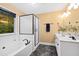 Modern bathroom with double vanity, soaking tub, and glass shower at 120 Rosewall Ln, Cary, NC 27511