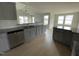 Modern kitchen with granite countertops, gray cabinets, and stainless steel appliances at 116 Lotus Ave, Smithfield, NC 27577