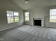 Bright living room featuring a cozy fireplace and large windows at 116 Lotus Ave, Smithfield, NC 27577