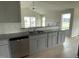 Open kitchen with granite countertops, stainless steel appliances, and island at 116 Lotus Ave, Smithfield, NC 27577