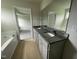Double vanity bathroom with granite countertops and a large soaking tub at 116 Lotus Ave, Smithfield, NC 27577