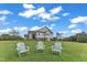 Three chairs on the lawn overlooking the house and landscape at 1618 Ben Wilson Rd, Mebane, NC 27302