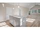 Kitchen island with granite countertop and grey cabinets at 325 Natchez Trce, Fuquay Varina, NC 27526