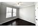 Bright bedroom with dark hardwood floors and two large windows at 609 Meadowgrass Ln, Wake Forest, NC 27587