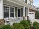 Inviting front porch with stone accents and a two-car garage at 609 Meadowgrass Ln, Wake Forest, NC 27587