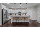 Modern kitchen with white cabinets, granite countertops, and island at 609 Meadowgrass Ln, Wake Forest, NC 27587