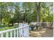 Deck with wooden railings overlooking a wooded area at 808 N Lincoln St, Benson, NC 27504