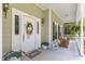 Inviting front porch with a rocking chair and lush landscaping at 808 N Lincoln St, Benson, NC 27504