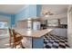 Eat-in kitchen with light blue cabinetry, checkerboard floor, and island at 816 Luby Smith Rd, Princeton, NC 27569