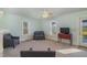 Bright living room with two armchairs, a sofa, and access to a back porch at 816 Luby Smith Rd, Princeton, NC 27569