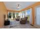 Sunroom with two comfy armchairs, a ceiling fan, and views of the backyard at 816 Luby Smith Rd, Princeton, NC 27569