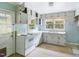 Kitchen with white cabinets, appliances, and a double sink at 260 S Rocky River Rd, Moncure, NC 27559
