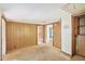 Small bedroom with wood paneling and carpeted floors at 260 S Rocky River Rd, Moncure, NC 27559