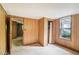 Bedroom with wood paneling, carpet, and closet at 260 S Rocky River Rd, Moncure, NC 27559