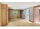 Simple dining area with wood paneling and kitchen access at 260 S Rocky River Rd, Moncure, NC 27559