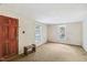 Empty bedroom with wood paneling, carpet, and a window at 260 S Rocky River Rd, Moncure, NC 27559