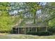 Gray house with screened porch and mature landscaping at 260 S Rocky River Rd, Moncure, NC 27559