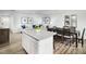 Open concept dining area with kitchen island and hardwood floors at 6672 Gibraltar Rock Dr # 1083C, Raleigh, NC 27610