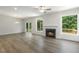 Bright living room featuring hardwood floors, fireplace, and sliding glass doors to deck at 113 Quail Point Cir, Clayton, NC 27520