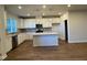 Modern kitchen with island, stainless steel appliances, and white cabinets at 605 Hillfarm Dr, Wake Forest, NC 27587