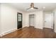 Bright bedroom with hardwood floors, a closet, and a black door at 221 W Dale Dr, Oxford, NC 27565