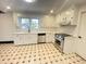 Renovated kitchen with white cabinets and stainless steel appliances at 221 W Dale Dr, Oxford, NC 27565