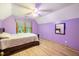 Purple bedroom with wood floors and a window at 229 Turnipseed Rd, Wendell, NC 27591