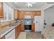 Modern kitchen with granite countertops and stainless steel appliances at 215 Eyam Hall Ln, Apex, NC 27502