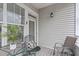 Small balcony with metal table and chairs, offering a peaceful outdoor space at 215 Eyam Hall Ln, Apex, NC 27502