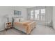 Bedroom with a double bed, nightstand, and large windows at 215 Eyam Hall Ln, Apex, NC 27502