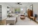 Inviting living room filled with natural light, with large windows, comfortable furniture, and a ceiling fan at 1110 Greatland Rd, Durham, NC 27703