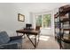 Well-lit home office with ample workspace, built-in shelving, and natural light at 1110 Greatland Rd, Durham, NC 27703