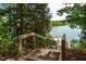 Wooden stairs leading down to a lake dock at 1172 Holding Village Way, Wake Forest, NC 27587